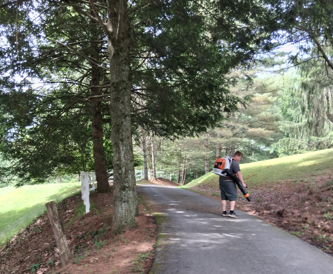 power blowing a driveway to prep for driveway sealing